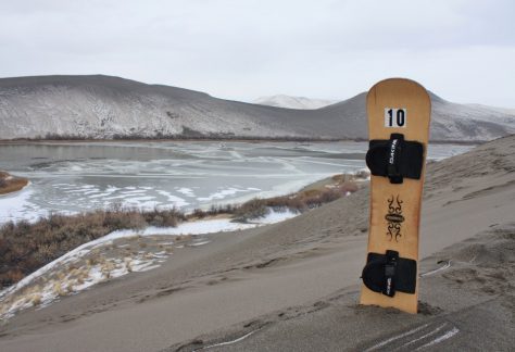 Lone sandboard in the sand on a winter day