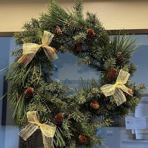 winter wreath with pinecones, spruce boughs, and burlap ribbon