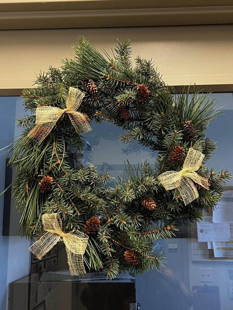 winter wreath with pinecones, spruce boughs, and burlap ribbon