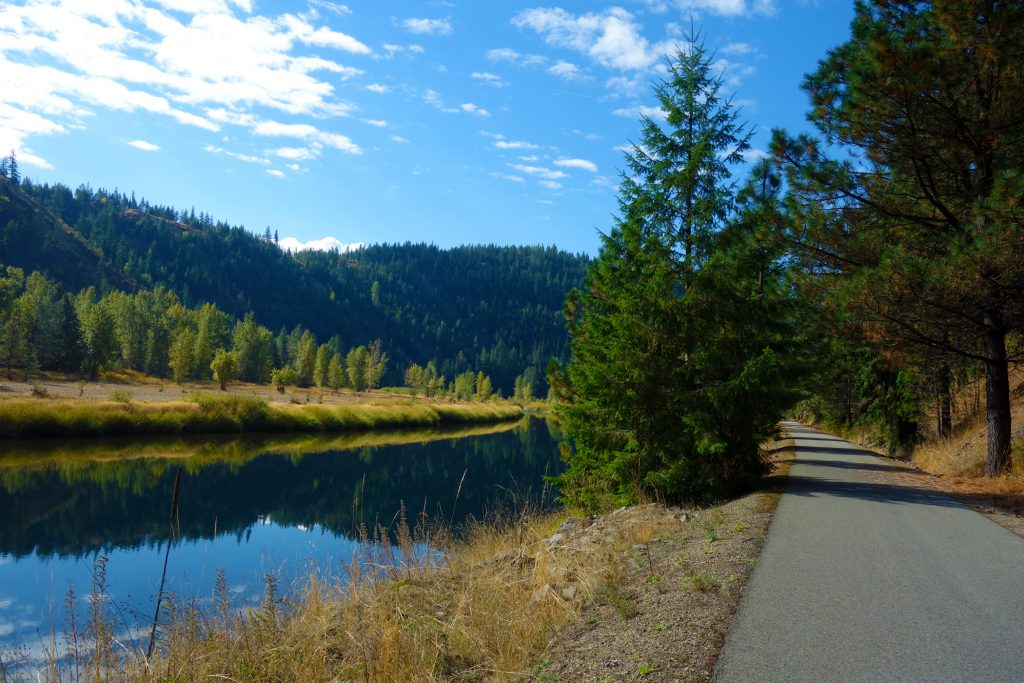 hard path trail next to water and mountains