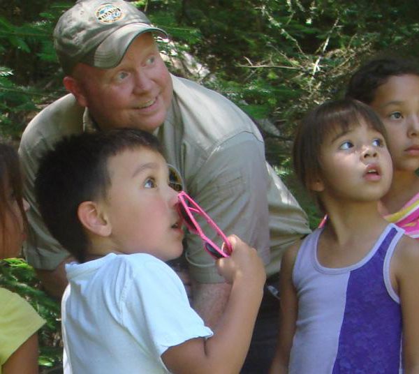 park ranger pictured with 4 kids