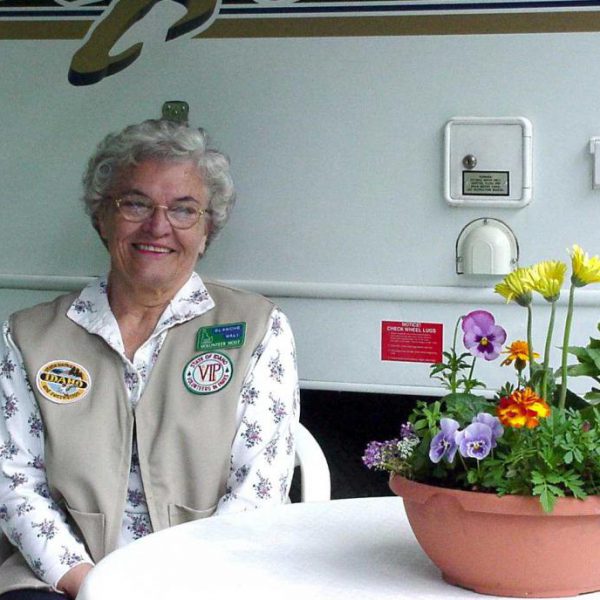 Farragut Host--Blanche Wall pictured in front of RV with flower pot