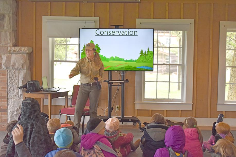 Ranger Morgan leading an environmental education presentation for a school group