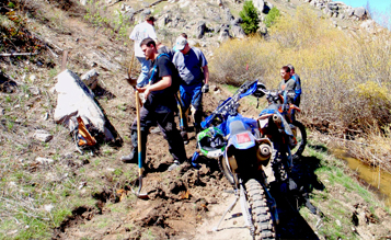 people on trail with dirtbike