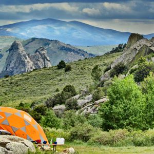 Orange dome tent set up under the granite spires of castle rocks state park