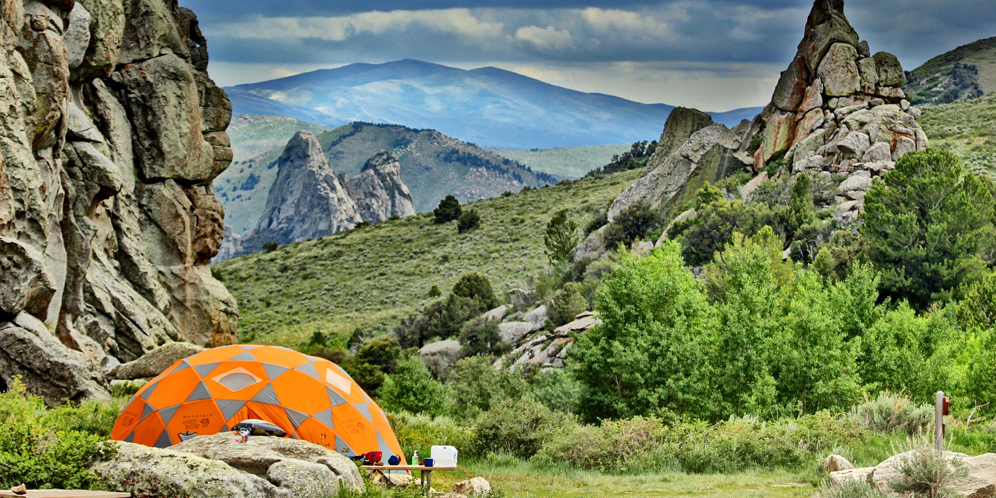 Orange dome tent set up under the granite spires of castle rocks state park