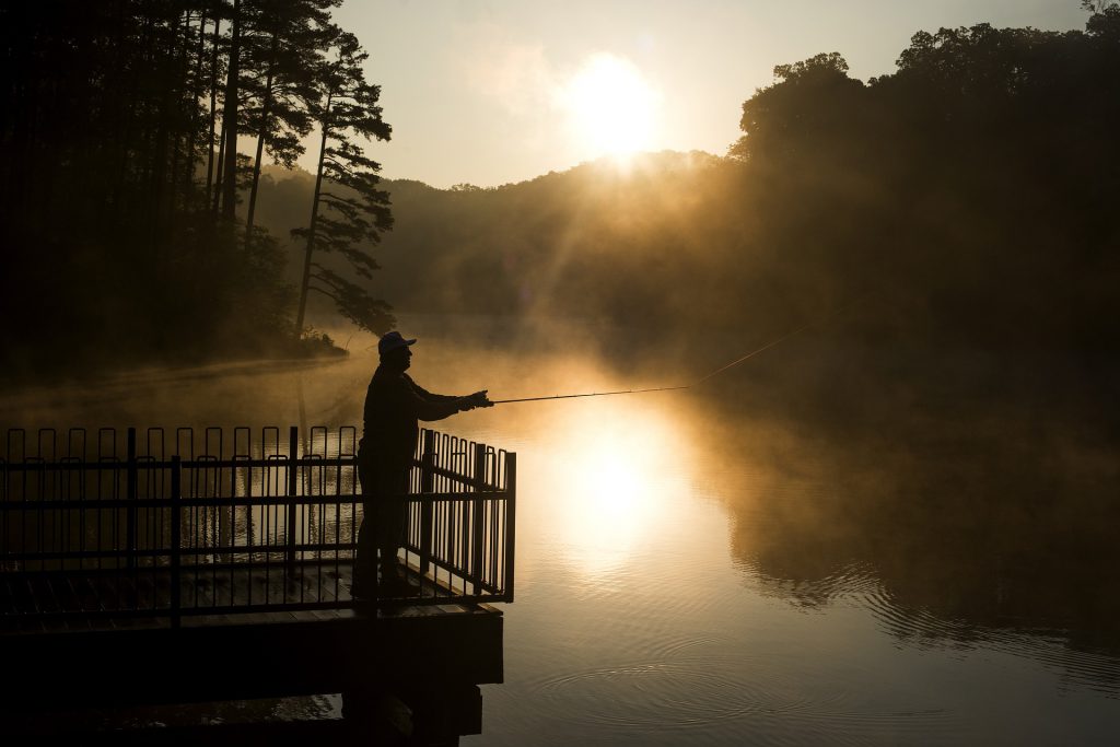 man fishing during sunrise