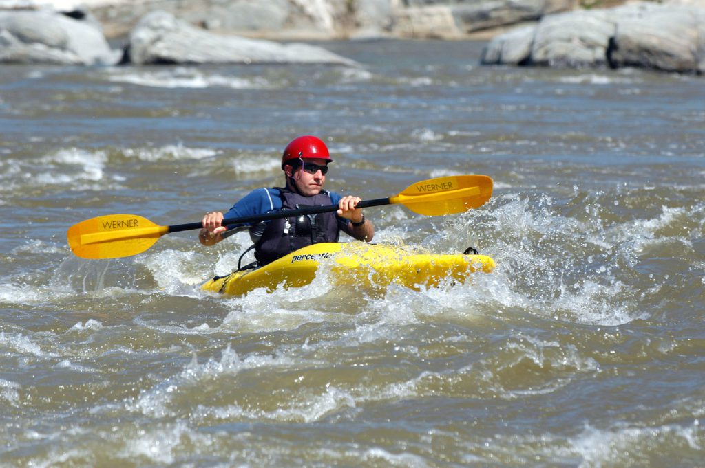 person kayaking in a river