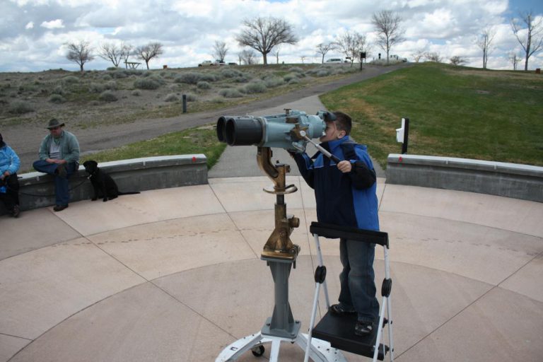 boy looking through telescope