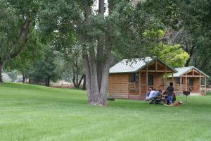 View of Three Island Crossing cabins with family at table