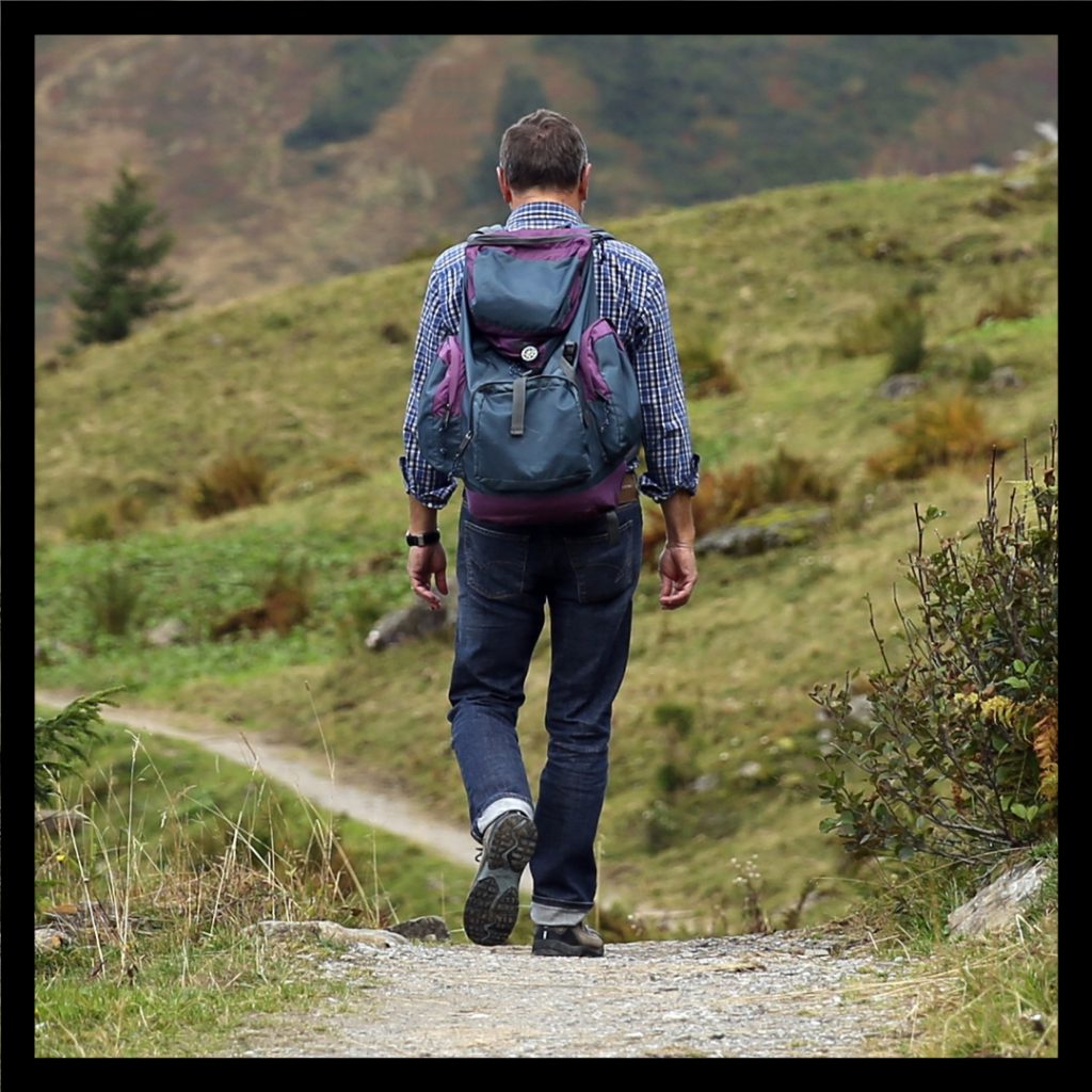 person walking on trail